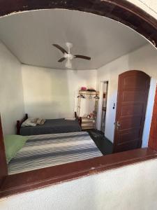 a bedroom with a bed and a ceiling fan at Cantinho do tricolor in Saquarema