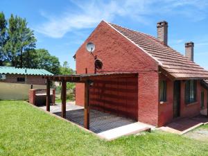 a red brick house with a large garage at El Encuentro in Piriápolis