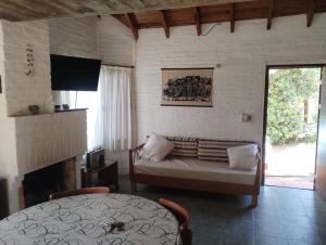 a living room with a couch and a window at El Encuentro in Piriápolis