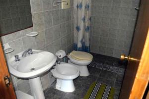 a bathroom with a toilet and a sink at El Encuentro in Piriápolis +23 photos