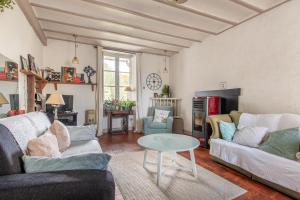 a living room with two couches and a table at La Maison Haute in La Fosse-de-Tigné
