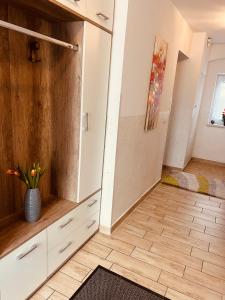 a room with white cabinets and a vase of flowers at Appartement Gombotz in Halbenrain