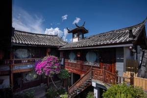 a building with a clock tower on top of it at 十二星客栈 in Lijiang