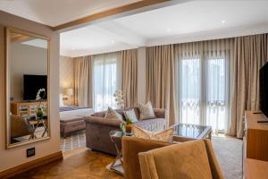 a living room with a couch and a mirror at Pivot Hotel Montecasino in Johannesburg