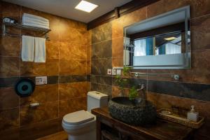 a bathroom with a sink and a toilet and a mirror at 十二星客栈 in Lijiang +130 photos