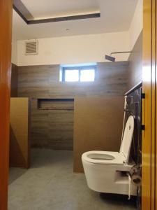 a bathroom with a white toilet in a room at Grandy Boutique hotel in Islamabad