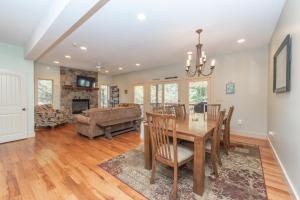 a dining room and living room with a table and chairs at Mystic Haven by Railey Vacations in Oakland