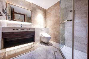 a bathroom with a toilet and a glass shower at ROLA&RICCI Hotel Chengdu East Branch in Chengdu +63 photos
