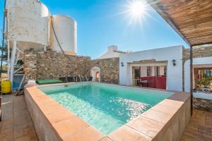 a villa with a swimming pool and a house at Cubo's Cortijo La Olivera in Antequera