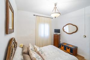 a living room with a couch and a mirror at Cubo's Cortijo La Olivera in Antequera