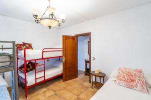 a bedroom with a bunk bed and a door at Cubo's Cortijo La Olivera in Antequera +40 photos
