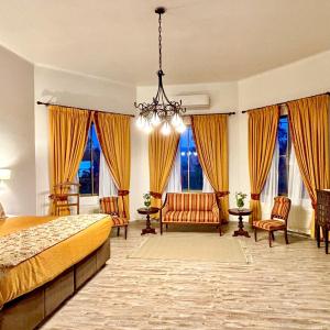 a bedroom with a bed and a chandelier at Resort Termas de Panimávida - Hotel & Spa in Panimávida +21 photos