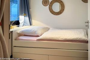 a bed in a room with a window at Luv und Lee in Schilksee