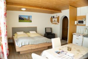 a small bedroom with a bed and a table at Appartement Isabella in Mieming +36 photos