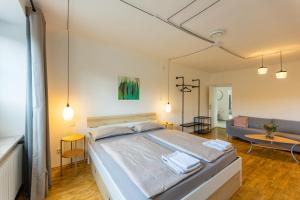a bedroom with a large bed and a living room at Landhaus Krell in Mitterretzbach