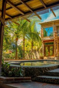 a mural of a swimming pool with palm trees on a wall at Casona Tunan in Santa María Mizata