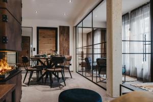 a dining room with a table and chairs and a fireplace at Parzivita Suites in Wolframs-Eschenbach