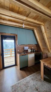 a kitchen with a sink and a table in a cabin at Villa Qukapiku in Orllan +1 photo