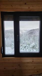 a window with a view of a snow covered field at Villa Qukapiku in Orllan