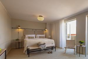 a bedroom with a large bed and a large window at Sandhamn Seglarhotell in Sandhamn +106 photos
