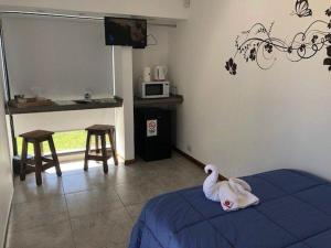 a room with a bed with a toy animal on it at Finca los Cauquenes Chascomus in Chascomús