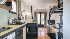 a kitchen with a sink and a stove at Le Birdie NI105 - ST2 in Giez