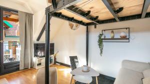 a living room with a couch and a table at Le Birdie NI105 - ST2 in Giez