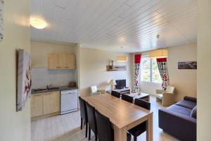 a kitchen and living room with a table and chairs at Laouen Blavezh'ti in Saint-Barthélemy +18 photos