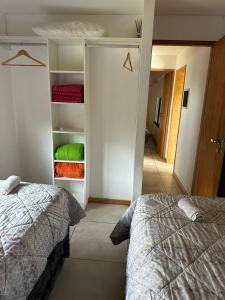 a bedroom with a bed and an open closet at Finca los Cauquenes Chascomus in Chascomús +8 photos