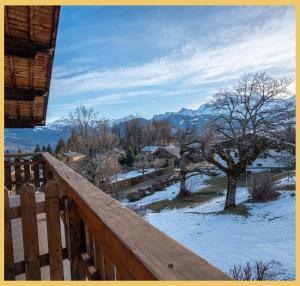 a view from the deck of a cabin in the snow at Le Balcon du Mont-BIanc I Duplex I Combloux in Combloux
