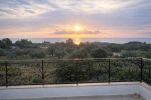 a view of the sunset from the balcony of a house at Exclusive Olive & Herb Villa, Mountain to Sea Views, Rhodes in Afantou