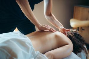 a man getting a back massage from a therapist at Broløkke Herregård in Humble