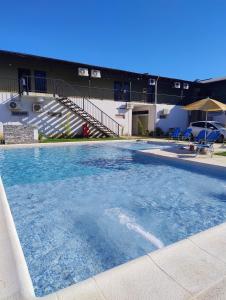 a large swimming pool in front of a building at Rdsa Paso in Paso de la Patria
