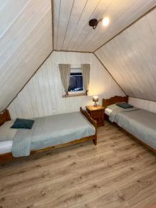 a room with two beds and a window at Grey House Istebna in Istebna