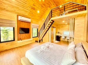 a bedroom with a large bed and a staircase at Nordic pool villa huahin6 in HHQ