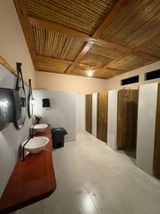 a bathroom with a sink and a toilet in it at Glamping in Lavrinhas