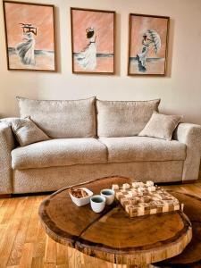 a living room with a couch and a table at Le Damier in Castres