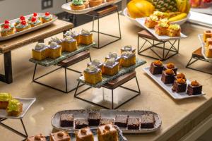 a display of different types of cakes and pastries at Hotel Cartagena Plaza in Cartagena de Indias