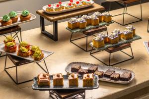 a display of different types of cakes and pastries at Hotel Cartagena Plaza in Cartagena de Indias +111 photos