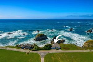 an aerial view of the ocean with a swan statue at Seaside Elegance Oceanfront Escape with 3 Suites in Bodega Bay