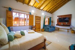 a bedroom with a bed with pillows and a television at Hotel Isla Lizamar in Isla Grande