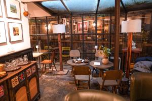 a room with tables and chairs and a library at POSHPACKER - Chengdu Mix Hostel - Cicada Zen Yard in Chengdu
