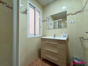 a bathroom with a sink and a mirror at El Piso Bajo in San Juan de Moró +28 photos