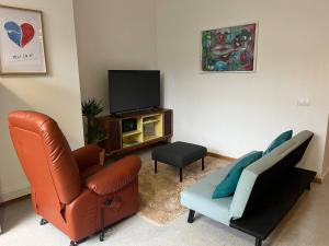 a living room with a couch and a television at 2Stay Porto in Porto