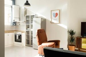 a living room with a chair and a refrigerator at 2Stay Porto in Porto