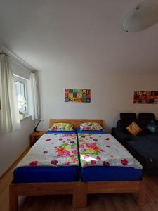 a bedroom with two beds and a couch at Charme Appartment in Freiburg im Breisgau +14 photos