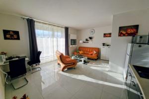 a living room with an orange couch at APARTMÁNY I&V - Adults Only in Pilsen