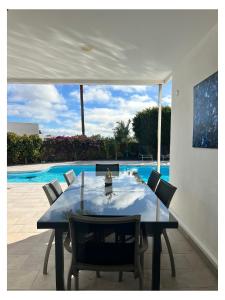 a dining table and chairs under a white tent at Villa Infinity Exclusive in Tías +32 photos