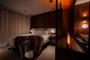 a hotel room with a bed and a fireplace at Cave Hotel & Golf Resort in Faversham