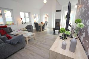 a living room with a couch and a table at Feriendorf Südstrand Haus 11 in Pelzerhaken